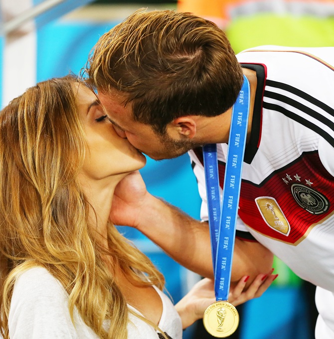 Mario Goetze of Germany kisses girlfriend Ann-Kathrin Brommel after defeating Argentina