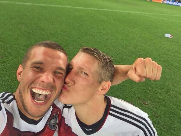 Bastian Schweinsteiger plants a kiss on Lucas Podolski 