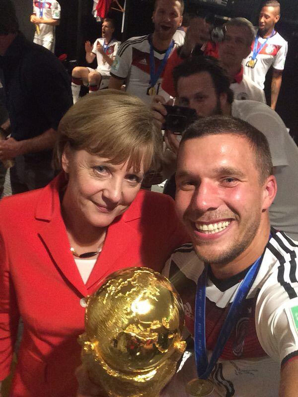 German Chancelor Angela Merkel shares the frame with Lucas Podolski