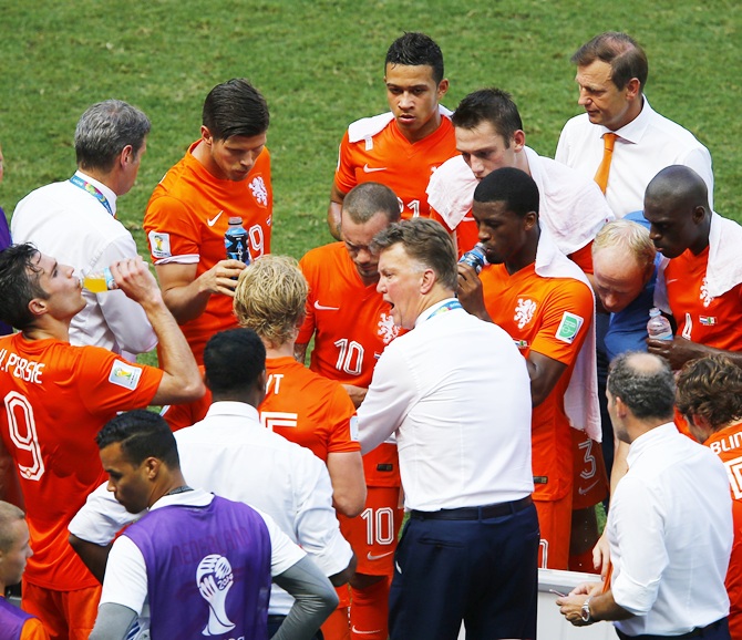 Netherlands coach Louis van Gaal, centre, speaks to his players during a cooling break