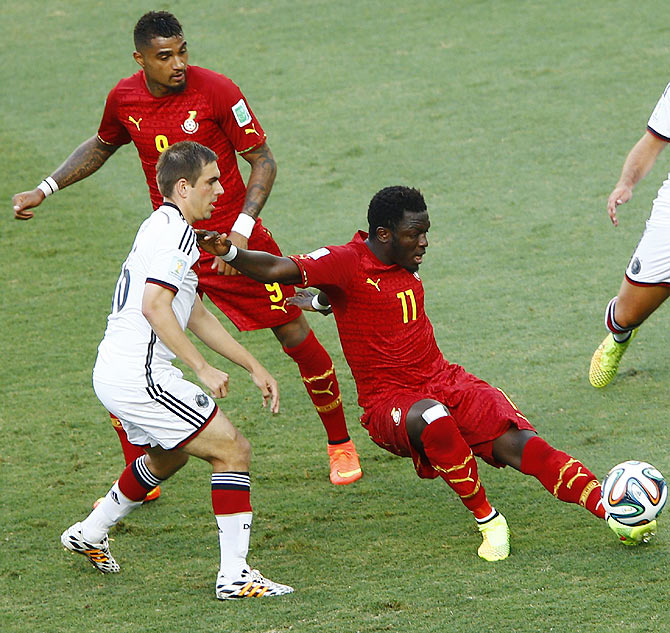 Germany's Philipp Lahm (left) fights for the ball with Ghana's Sulley Muntari (right) and Kevin-Prince Boetang