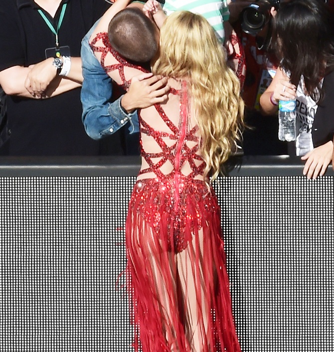 Gerard Pique of Spain hugs musician Shakira after her performance