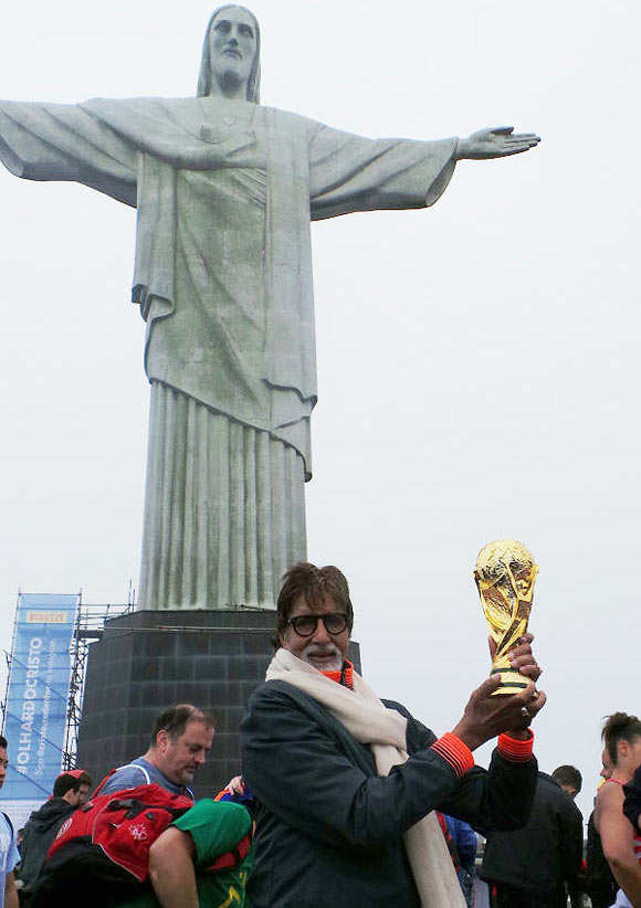 Amitabh Bachchan poses with a replica of the World Cup at 'Christ the Redeemer' in Rio de Janeiro