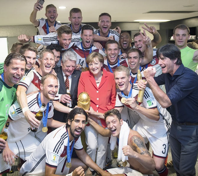 In this handout photo provided by the German Government Press Office (BPA),   German Chancellor Angela Merkel and German President Joachim Gauck celebrate with the   German national team after it's 1-0 victory in the 2014 FIFA World Cup in Brazil
