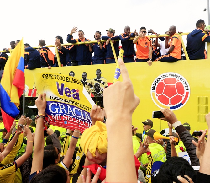 Colombia's national soccer team players are greeted by fans, at their arrival in Bogota