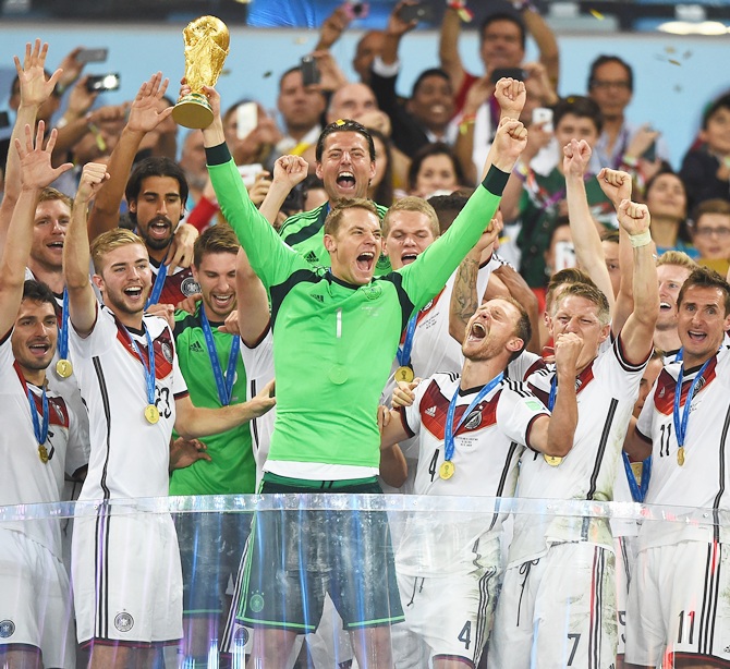 Manuel Neuer of Germany lifts the World Cup trophy with his team after defeating Argentina 1-0