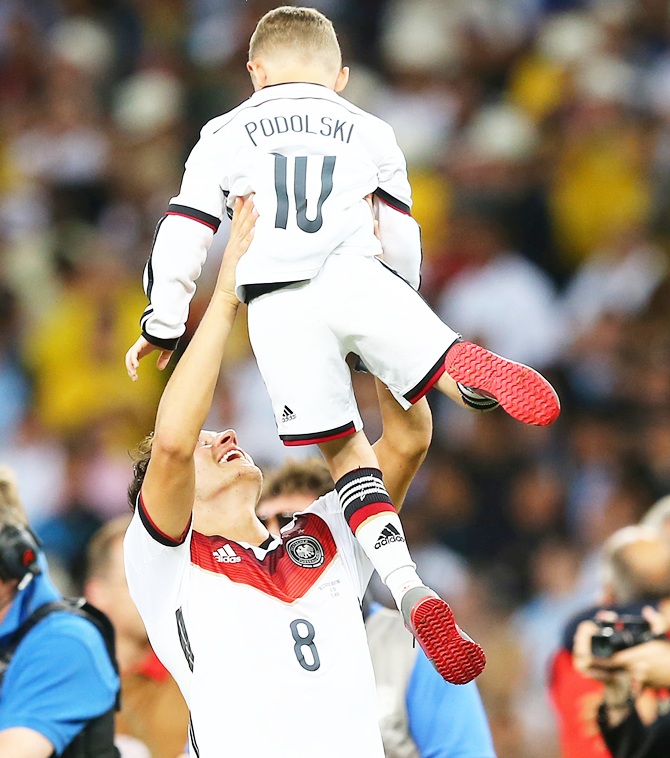 Mesut Oezil with Lukas Podolski's son