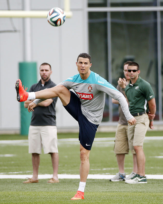 Portugal's Cristiano Ronaldo (centre) warms up during a training session