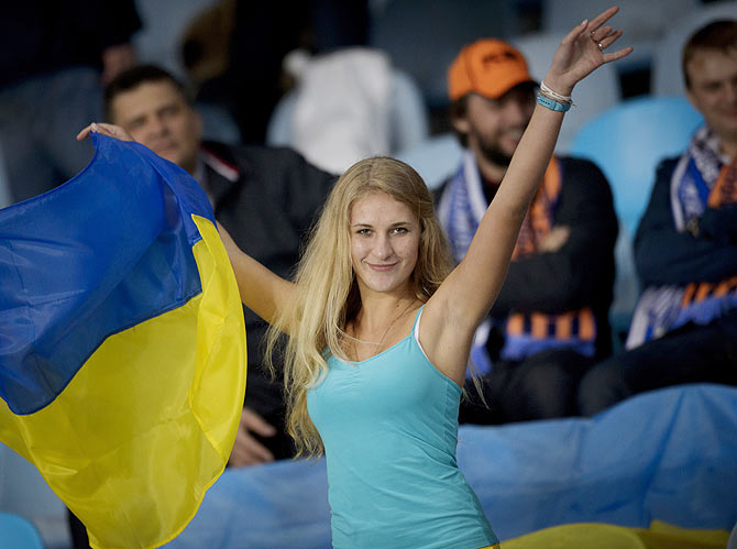 An FC Shakhtar Donetsk supporter cheers during a match