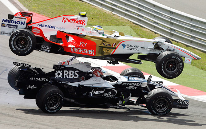Force India Formula One driver Giancarlo Fisichella of Italy (top) clashes with Williams driver Kazuki Nakajima of Japan