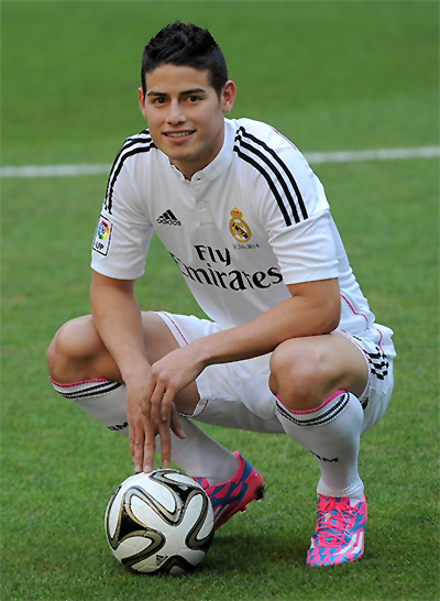 James Rodriguez poses for photographers during his unveiling as a new Real Madrid player at the Santaigo Bernabeu