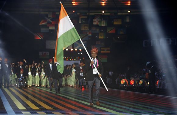 India's flag is carried by Vijay Kumar during the opening ceremony for the 2014 Commonwealth Games at Celtic Park in Glasgow