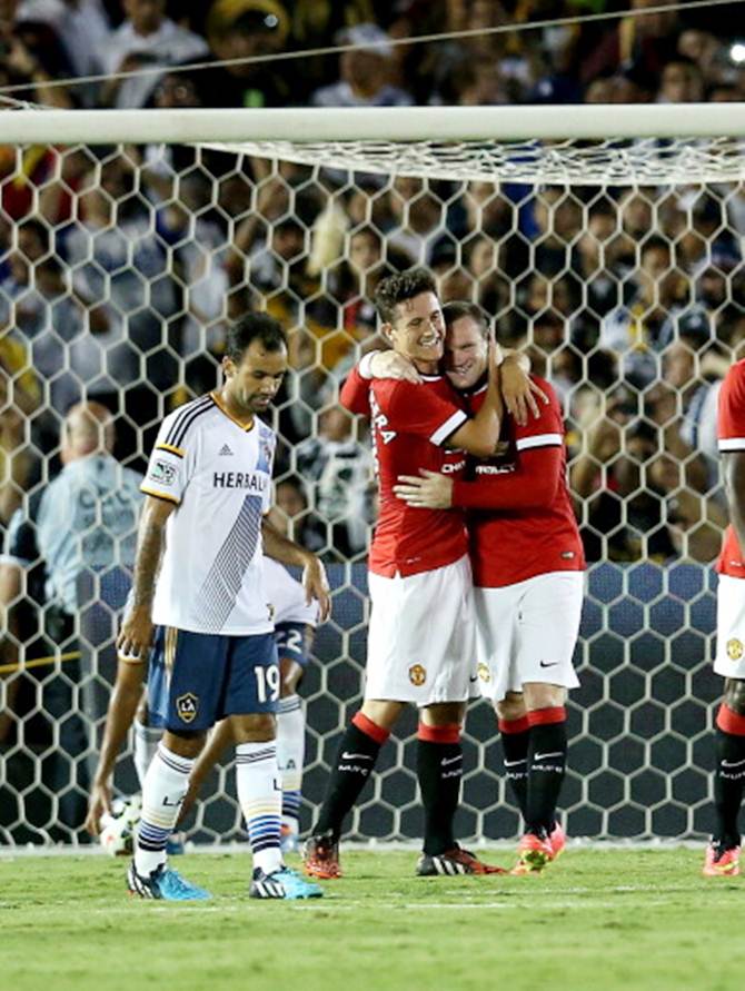 Wayne Rooney (right) of Manchester United celebrates with Ander Herrera after scoring from a penalty kick as Juninho (#19) of the Los Angeles Galaxy reacts