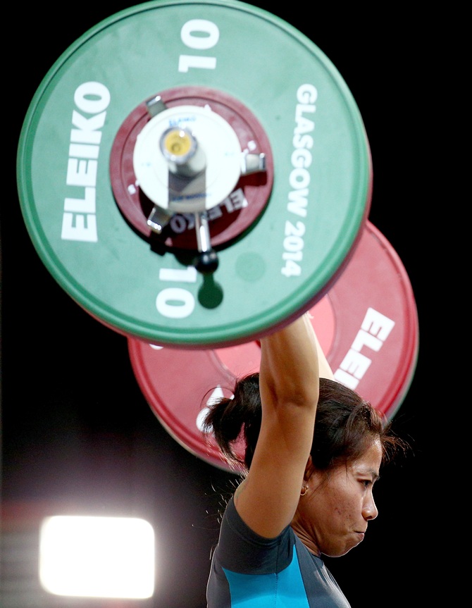 Sanjita Chanu Khumukcham of India competes in the Clean and Jerk on her way to winning the gold medal in the women's 48kg weightlifting at the Scottish Exhibition And Conference Centre during Day 1 of the Glasgow 2014 Commonwealth Games