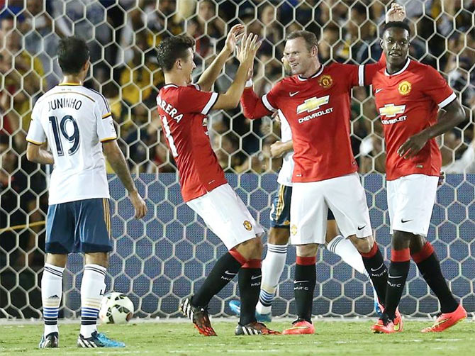 Wayne Rooney and Danny Wellbeck celebrate with Ander Herrera during the match against LA Galaxy