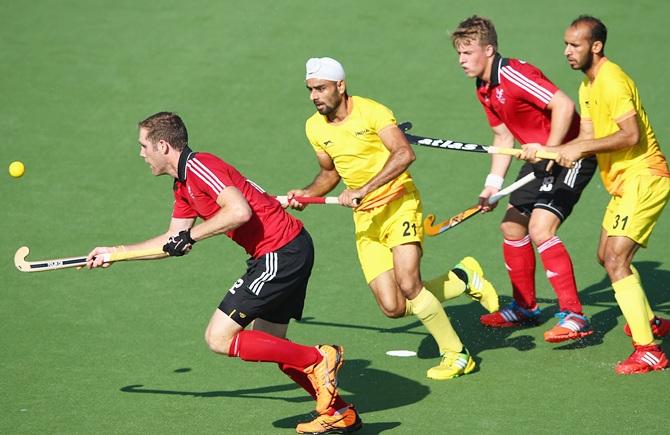 Gurwinder Chandi of India tries to trackle Richard Gay of Wales