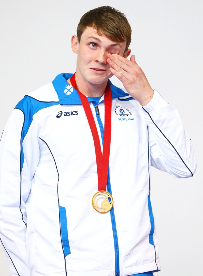 Gold medallist Ross Murdoch of Scotland wipes away tears during the medal ceremony for the   Men's 200m Breaststroke Final at Tollcross International Swimming Centre during day one of the Glasgow 2014 Commonwealth Games