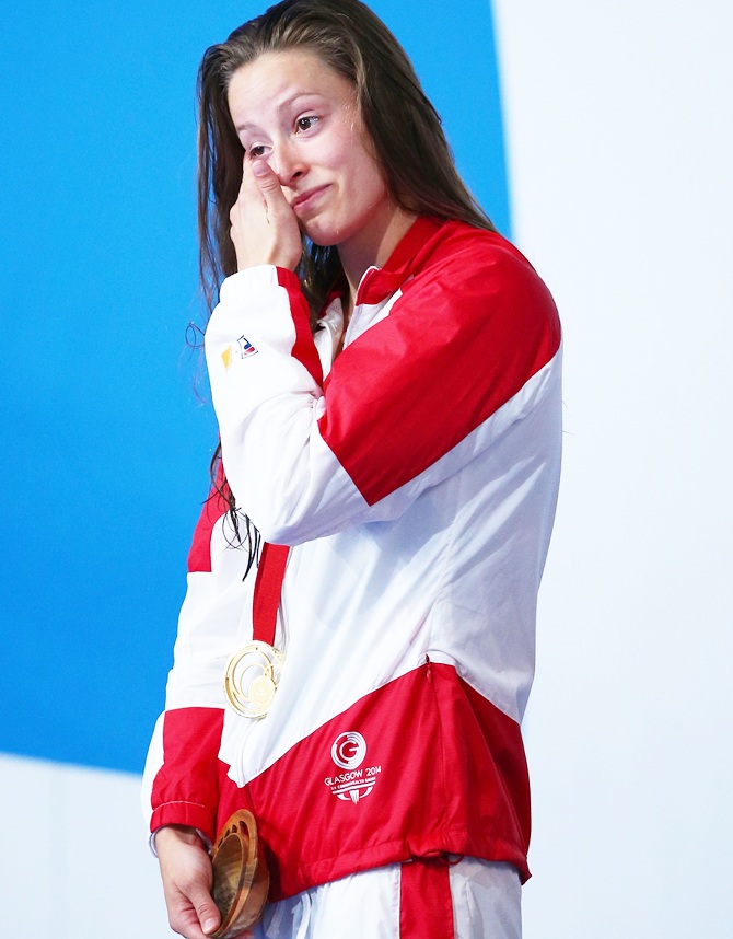 Gold medallist Katerine Savard of Canada wipes away tears