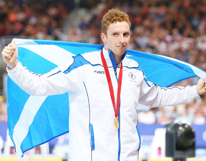 Gold medallist Daniel Wallace of Scotland poses after the medal ceremony for the Men's 400m Individual Medley Final at Tollcross International Swimming Centre during day two of the Glasgow 2014 Commonwealth Games