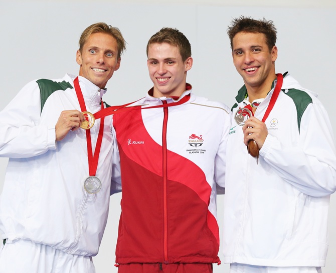 Gold medallist Benjamin Proud, centre, of England poses with silver medallist Roland Schoeman of South Africa and bronze medallist Chad le Clos of South Africa