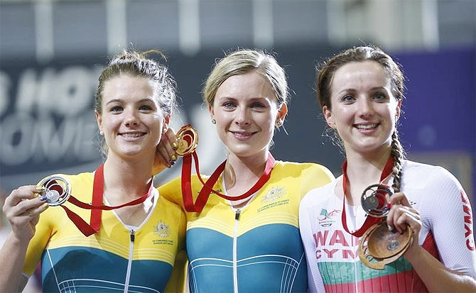 Australia's Annette Edmondson (centre) holds her gold medal with compatriot and silver medal winner Amy Cure (left) and bronze medal winner Elinor Barker of Wales after the women's 10km scratch cycling race at the 2014 Commonwealth Games in Glasgow, Scotland on Saturday
