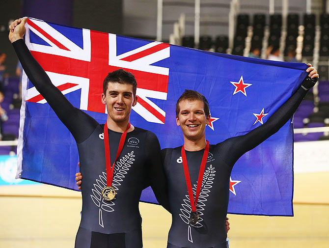 Gold medalist Tom Scully of New Zealand (ledt) and bronze medalist Aaron Gate of New Zealand celebrate during the medal ceremony for the Men's 40km Points Race final at Sir Chris Hoy Velodrome on Saturday