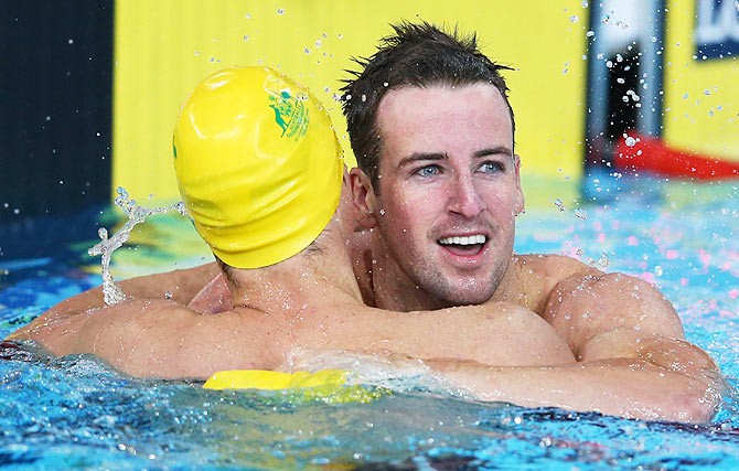 James Magnussen of Australia celebrates winning the gold medal in the Men's 100m Freestyle Final with silver medallist Cameron McEvoy of Australia at Tollcross International Swimming Centre on Sunday