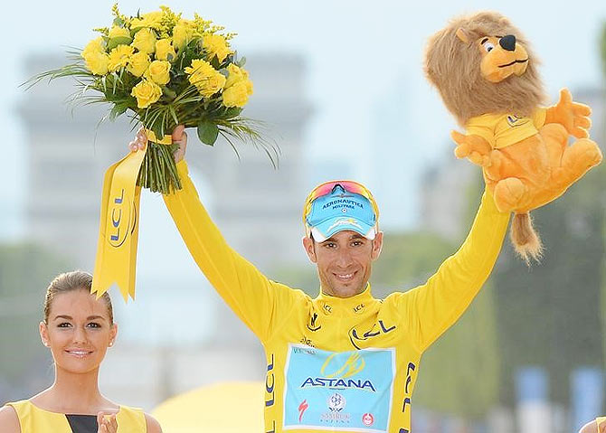 Astana team rider Vincenzo Nibali of Italy celebrates his overall victory on the podium after the 137.5 km final stage of the 2014 Tour de France, from Evry to Paris Champs Elysees on Sunday