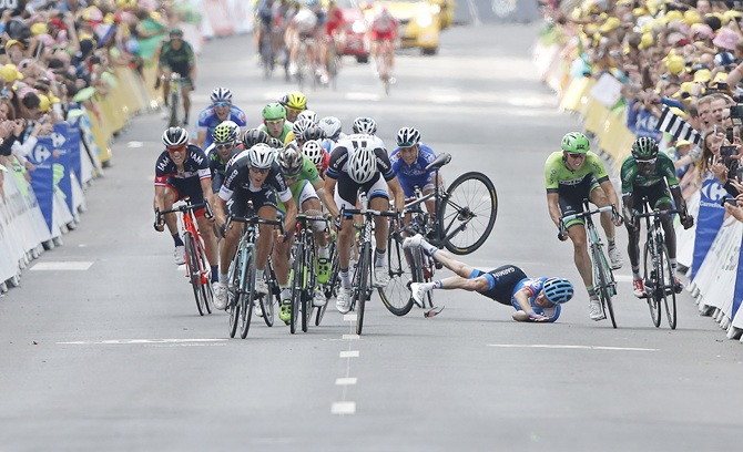 Garmin-Sharp team rider Andrew Talansky of the US crashes as   Omega Pharma-Quick Step team rider Matteo Trentin of Italy (left,front) sprints to win the   234.5 km seventh stage of the Tour de France cycling race from Epernay to Nancy on July 11