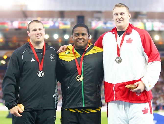 From left, Silver medalist Tom Walsh of New Zealand, gold medalist O'dayne Richards of Jamaica and bronze medalist Tim Nedow of Canada stand on the podium during the medal ceremony for the Men's shot put