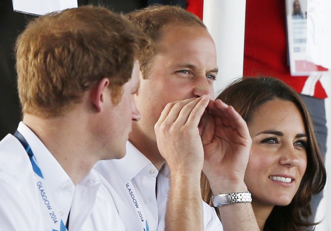 Catherine, Duchess of Cambridge, sits with her husband Britain's Prince William, right,  and Britain's Prince Harry as they watch artistic gymnastics