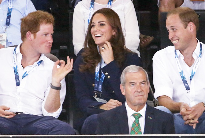  Prince William yells beside his wife Catherine, Duchess of Cambridge, and Britain's Prince Harry, left, as they watch hockey