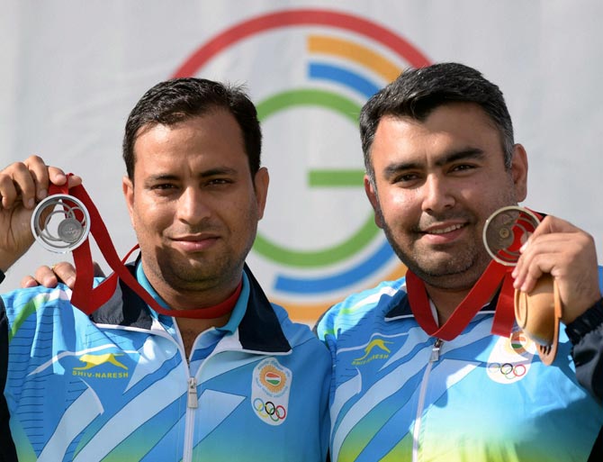 India's silver medal winner Sanjeev Rajput (left) and bronze medallist Gagan Narang
