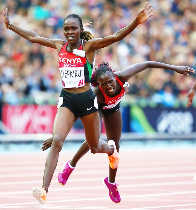 Joyce Chepkirui of Kenya crosses the line to win gold ahead of Florence Kiplagat of Kenya in the women's 10,000 metres final at Hampden Park during day six