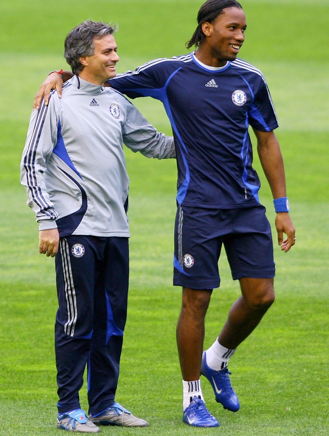 Chelsea Coach Jose Mourinho, right, shares a joke with Didier Drogba