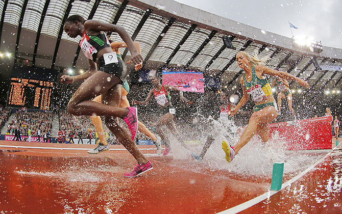 Cherotich Purity Kirui (left) of Kenya competes on her way to a first place finish in Women's 3000m Steeplechase Final at the 2014 Commonwealth Games on Wednesday