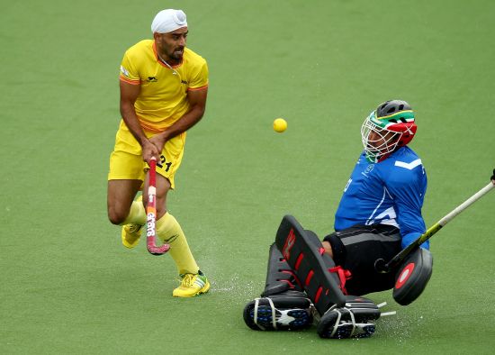 Erasmus Pieterse of South Africa makes a close save from a shot off India's Gurwinder Chandi