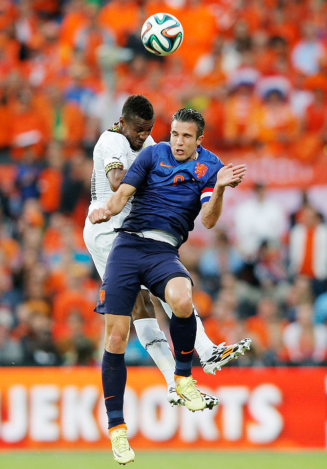Robin Van Persie of Netherlands and Jerry Akaminko of Ghana battle for the header during the International Friendly match at De Kuip in Rotterdam, Netherlands, on Saturday