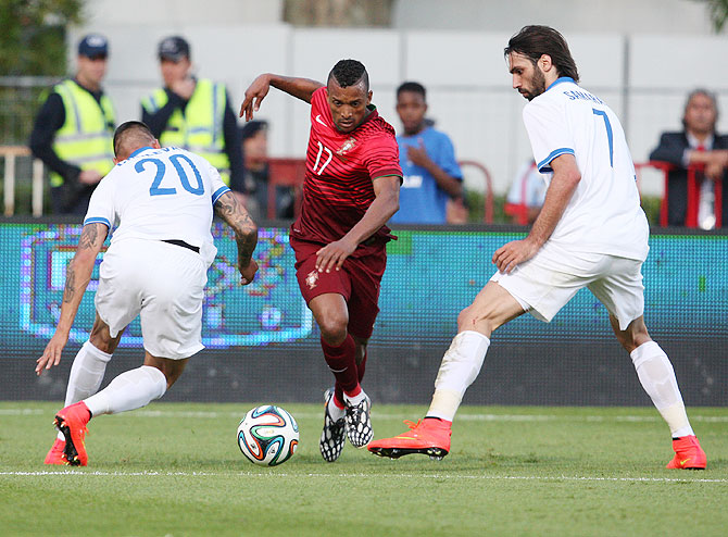 Nani of Portugal battles with Jose Holebas and Giorgos Samaras of Greece during the International Friendly at the National Stadium in Lisbon, Portugal, on Saturday