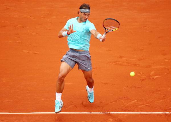 Rafael Nadal of Spain returns a shot in his men's singles match against Dusan Lajovic of Serbia at the French Open.
