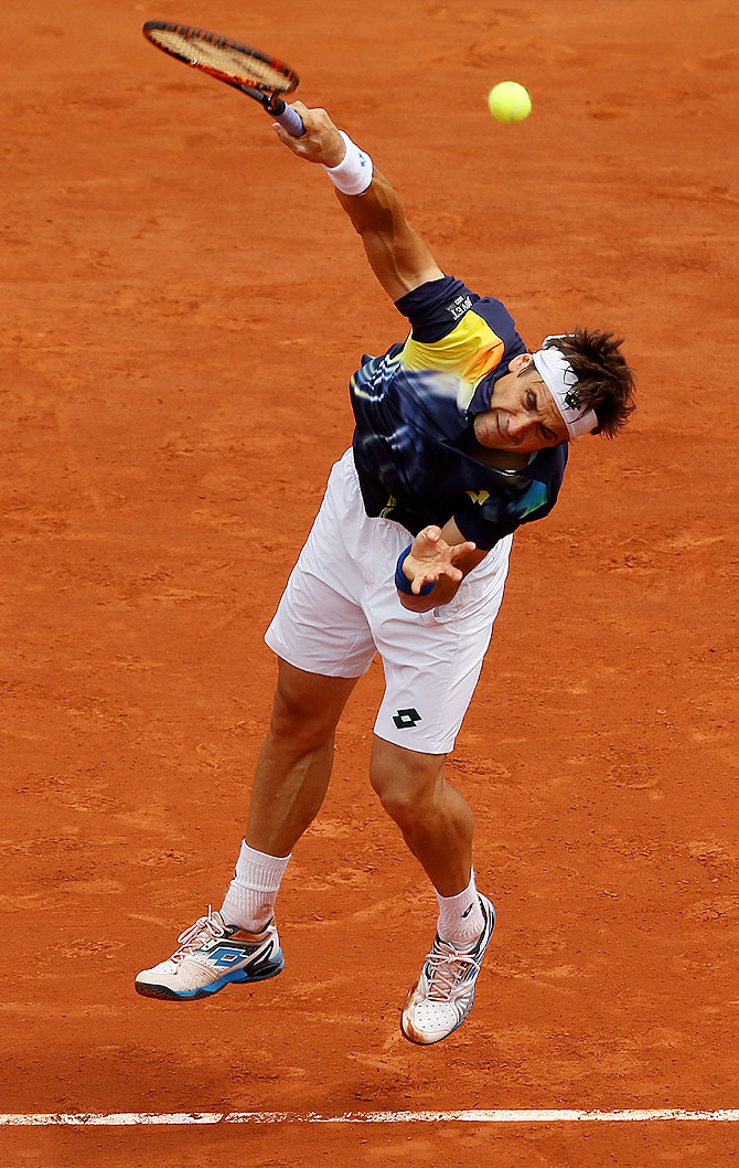 David Ferrer of Spain serves during his men's singles match against Kevin Anderson of South Africa.