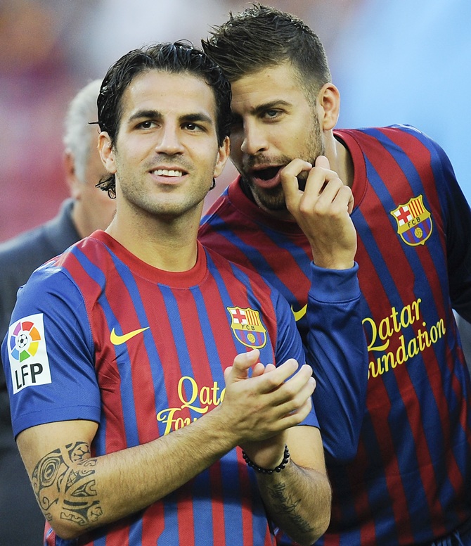 Cesc Fabregas,left, and Gerard Pique of FC Barcelona