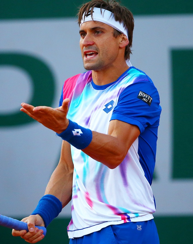 David Ferrer of Spain reacts during his men's singles match against Rafael Nadal of Spain