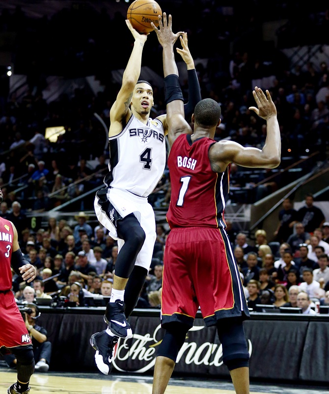Danny Green of the San Antonio Spurs takes a shot over Chris Bosh of   the Miami Heat