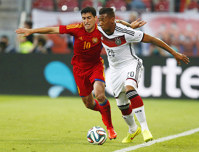 Germany's Jerome Boateng (right) challenges Armenia's Ghazaryan during their international friendly on Friday