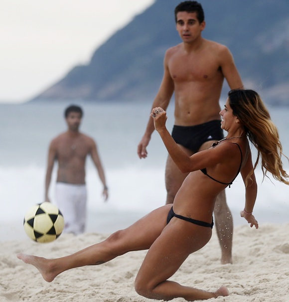 A couple enjoys Sao Conrado beach during summer in Rio de Janeiro.