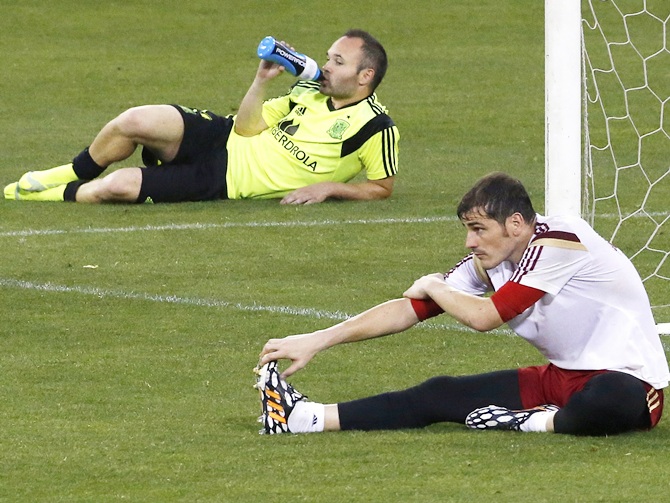 Spain's national soccer team goalkeeper Iker Casillas,right, and teammate Andres Iniesta stretch after a training session