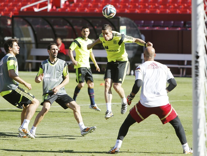 Fernando Torres,second right, heads a ball on goal as he participates in Spain's national soccer team training session