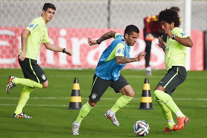 Brazil's Oscar, Daniel Alves and Dante take part in a training session at the squad's Granja Comary training complex, in Teresopolis, 90 km from downtown Rio de Janeiro, Brazil on Monday