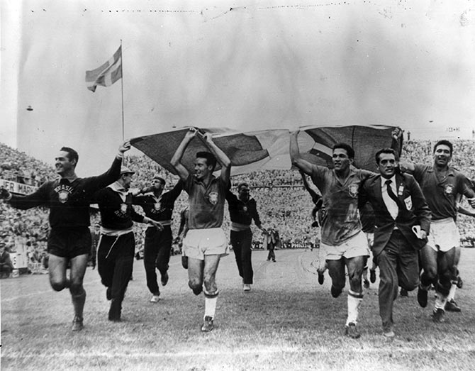 The Brazilian football team running with the Swedish flag after beating Sweden 5-2 in the 1958 World Cup final in Stockholm.